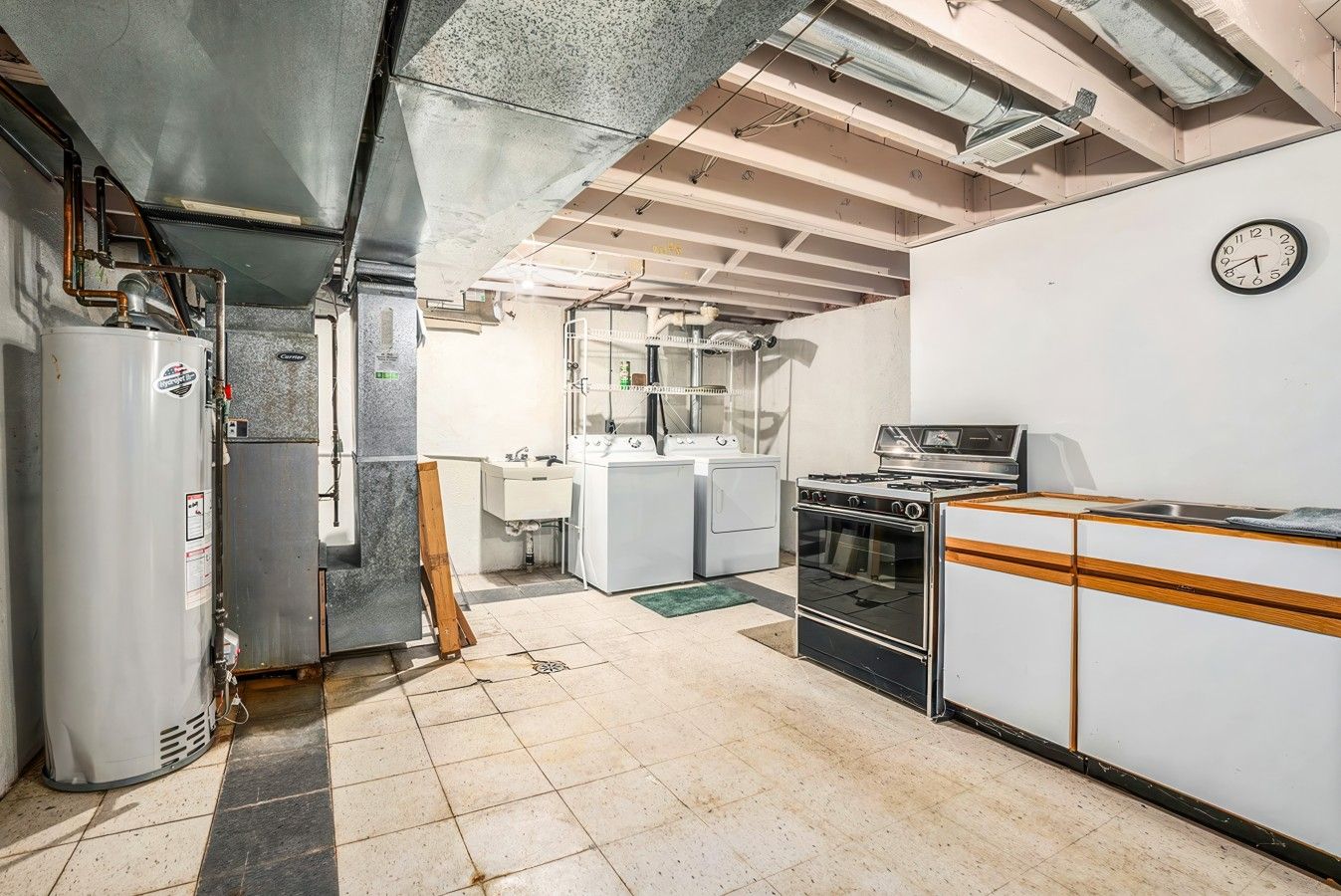 A kitchen with a stove, oven, and washing machine.