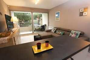 Ein modernes Wohnzimmer mit einer Couch, einem Couchtisch und einem Fernseher.