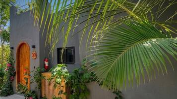 Un edificio con una puerta de madera identificada con el número 09, un extintor y una ventana.