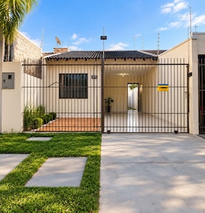 A gated entrance with a clear pathway leading to a building entrance.