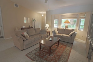A living room with two sofas, a coffee table, and a rug. - Serene West Facing Pool -Rotonda West #15 (Rotonda West)
