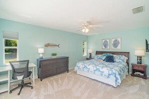 A bedroom with a bed, desk, chair, dresser, and a ceiling fan. - This house is a 2 bedroom(s), 2 bathrooms, located in Rotonda West, FL. (Rotonda West)