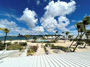 A resort with a pool, beach, and palm trees. - TI PARADISE Studio SXM Baie Nettlé on the Beach (Marigot)