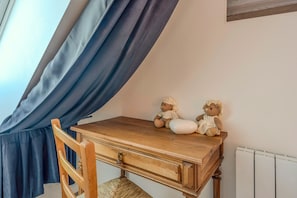 A wooden desk with two teddy bears, a chair, and a window with blue curtains. - Villa Les Mouettes - Face à la baie (Saint-Michel-en-Grève)