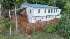 A two-story house with a deck, a covered porch, and a flagpole. - Lake Views, Soaking Tub, Ping Pong Table, Firepit (Sharps Chapel)