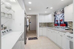 A modern kitchen with white cabinetry, a stainless steel range, and a tiled backsplash. - Atlantic City Home Near Boardwalk & Casinos (Atlantic City)