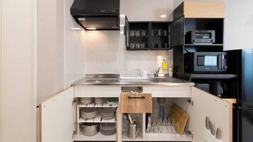 A modern kitchen with built-in appliances, a microwave, and a range hood.