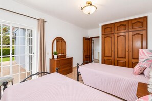 A bedroom with two beds, a dresser, a mirror, and a wardrobe. - Villa Silva Balbina - Four Bedroom Villa, Sleeps 8 (Albufeira)