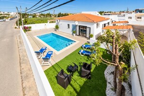 A residential property with a swimming pool, outdoor seating, and a well-maintained lawn. - Villa Dela - Two Bedroom Villa, Sleeps 4 (Vale Rebelho)