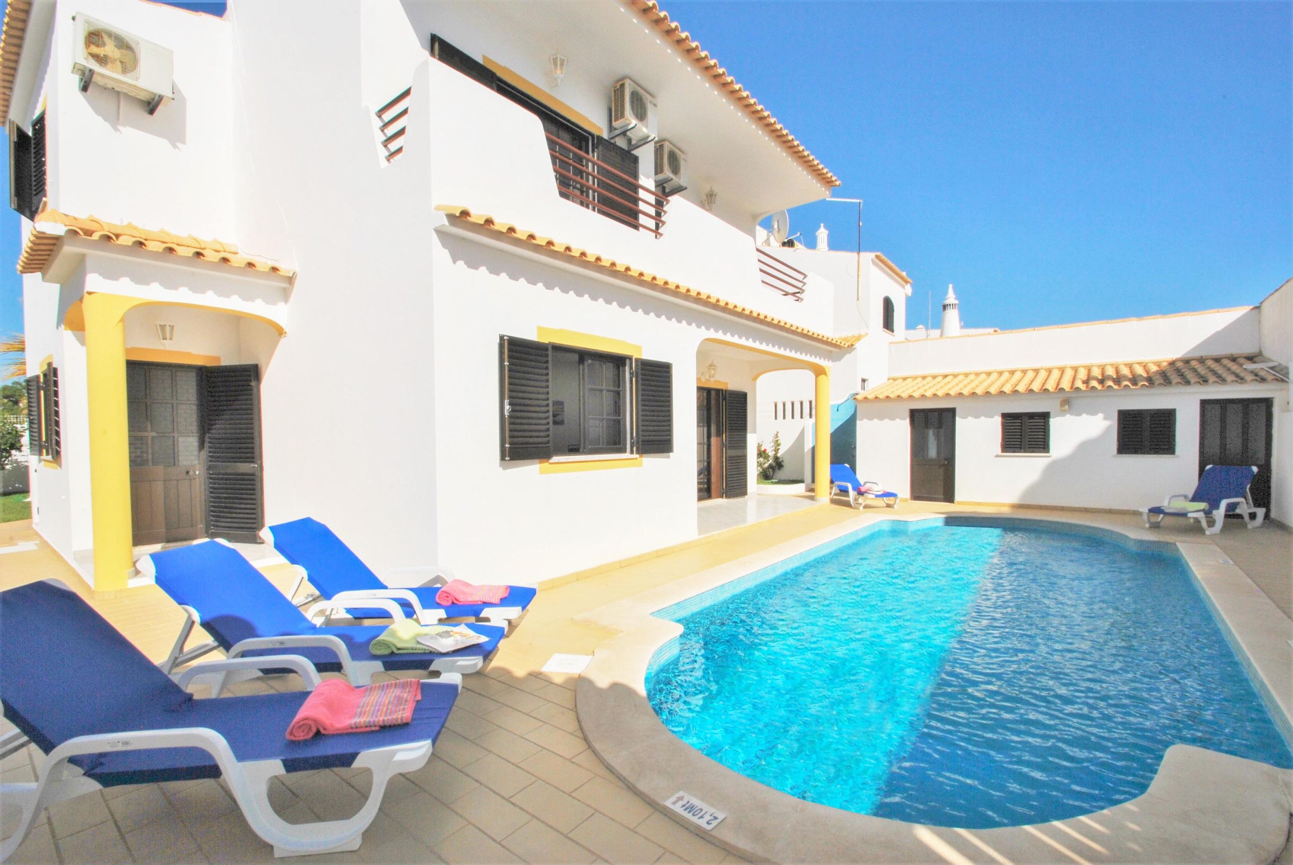 A poolside area with lounge chairs and a swimming pool.