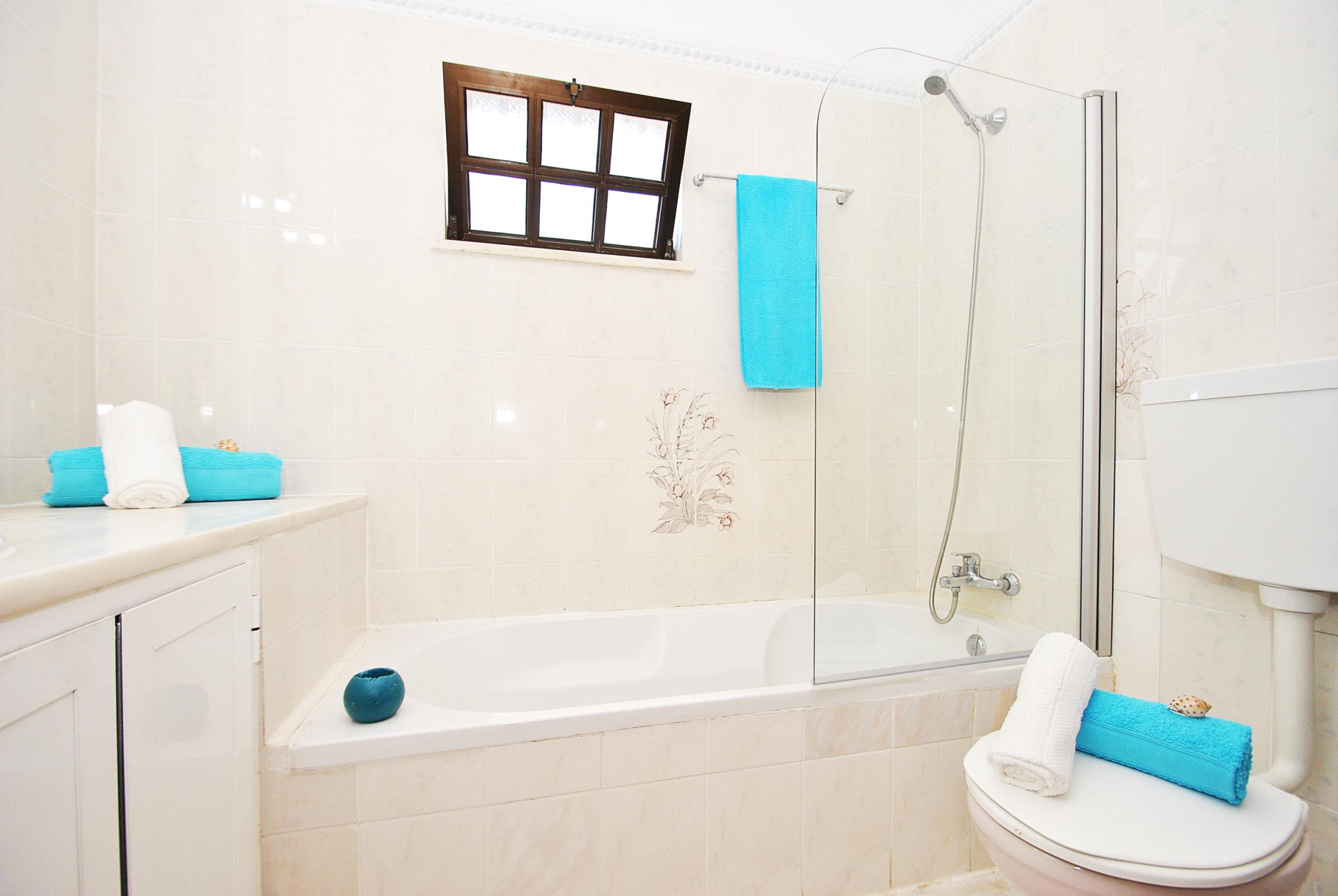 A bathroom with a bathtub, toilet, and shower.