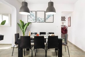 A dining area with a glass table, black chairs, and pendant lighting. - Villa Garden | Pool | Billiard | BBQ | Fireplace (Vélez-Málaga)