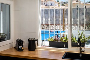 A kitchen with a coffee maker, a kettle, and a sink. - Villa Botanic | Pool | Ping Pong | Fireplace (Rincon de la victoria)