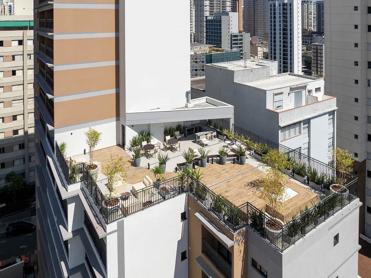 A rooftop terrace with outdoor seating and potted plants.