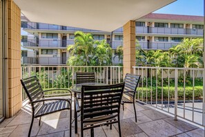 A comfortable table setting makes this private lanai just right for a slow breakfast among the palms. - Haleakala Shores A206 by Gather - Remodeled Condo Across from Kamaole Beach III (Kihei)