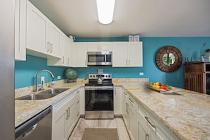 Room to actually cook: wraparound granite, a deep double sink, and a full-size range. - Kihei Alii Kai C206 by Gather - Rebuilt 1BR w/ Ocean & Mountain Lanai Views (Kihei)