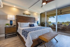 Ocean and palm fill the primary suite's sliding doors, the first thing this room shows you. - Kamaole Beach Royale 610 by Gather - Ocean View, 1 Blk to Beach, Fully AC'd (Kihei)