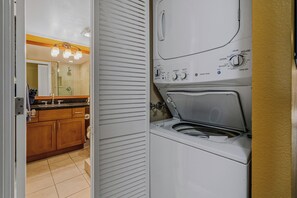 Beach towels get the sand rinsed out right here, stacked washer and dryer tucked into their own closet. - Kamaole Sands 5310 by Gather - South Kihei Condo w/ Pool View & Ocean Glimpse (Kihei)
