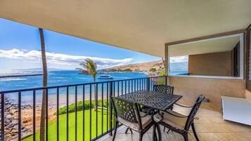 By day the lanai table seats three, with the green lawn and the marina both in view.