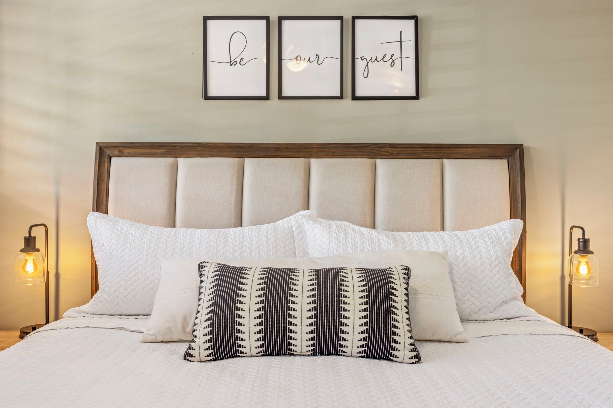 Wake up under the three framed prints spelling out the welcome above the bed.