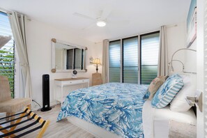 Soft window light and a ceiling fan turn this bedroom into an easy afternoon nap spot. - Punahoa Beach 205 by Gather - Oceanfront Condo w/ Private Lanai & Ocean Views (Kihei)