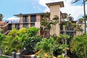 Tropical gardens and blooming plumeria wrap the walk in. - Punahoa Beach 205 by Gather - Oceanfront Condo w/ Private Lanai & Ocean Views (Kihei)