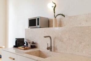 A kitchen with a sink, a microwave, and a plant on the countertop. - Tripas-Coração: Mouzinho32 1st Floor Apt E (Porto)