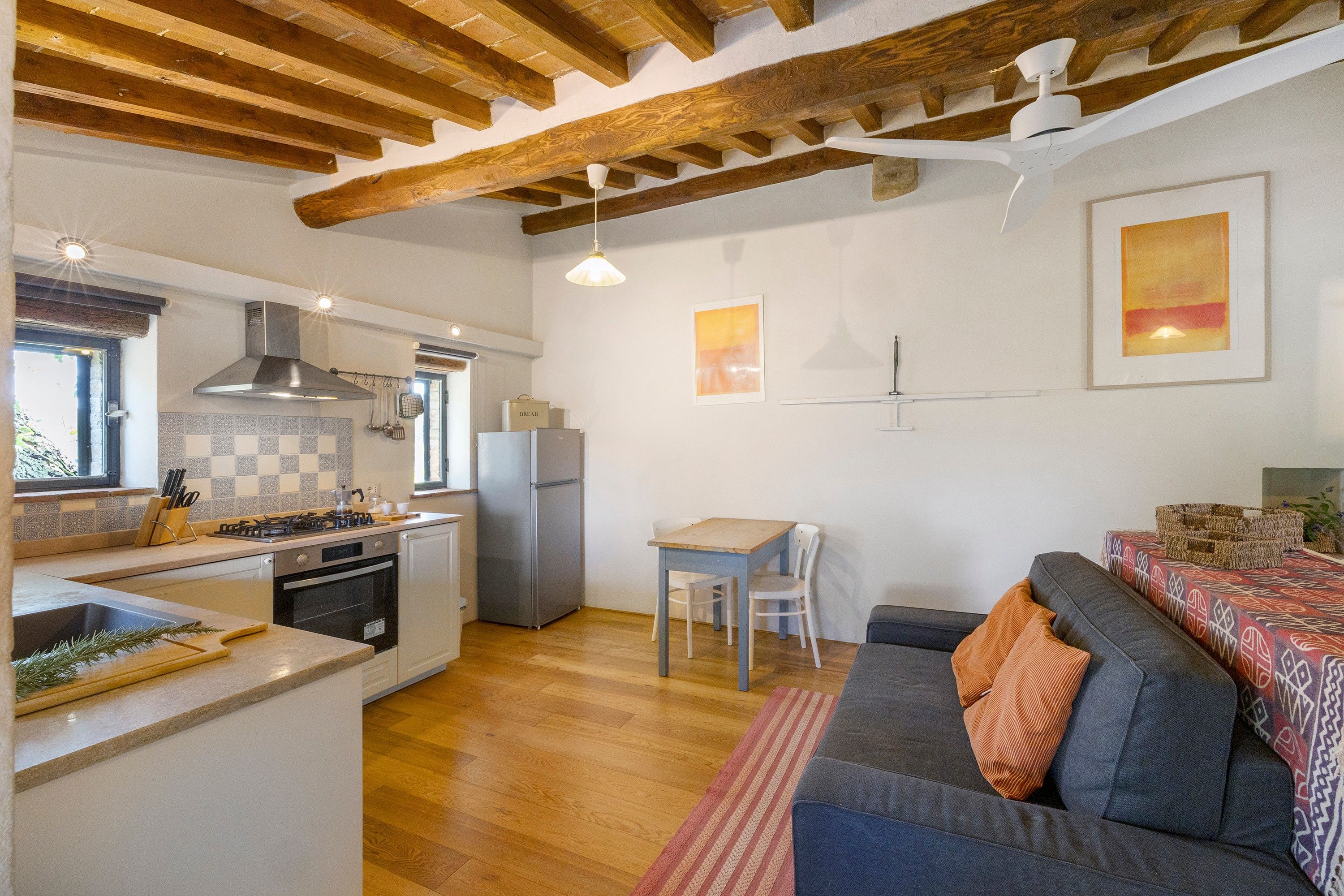 A compact kitchen with a gas stove, oven, and a built-in refrigerator.