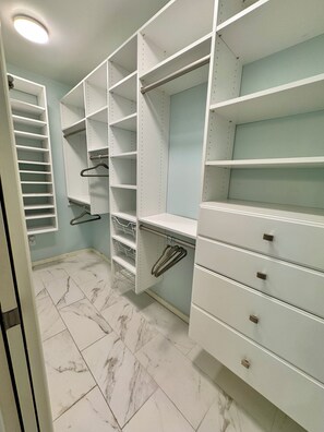 A walk-in closet with open shelving, drawers, and hanging space. - Walkable Top of Queen Anne 5BR + Parking (Seattle)