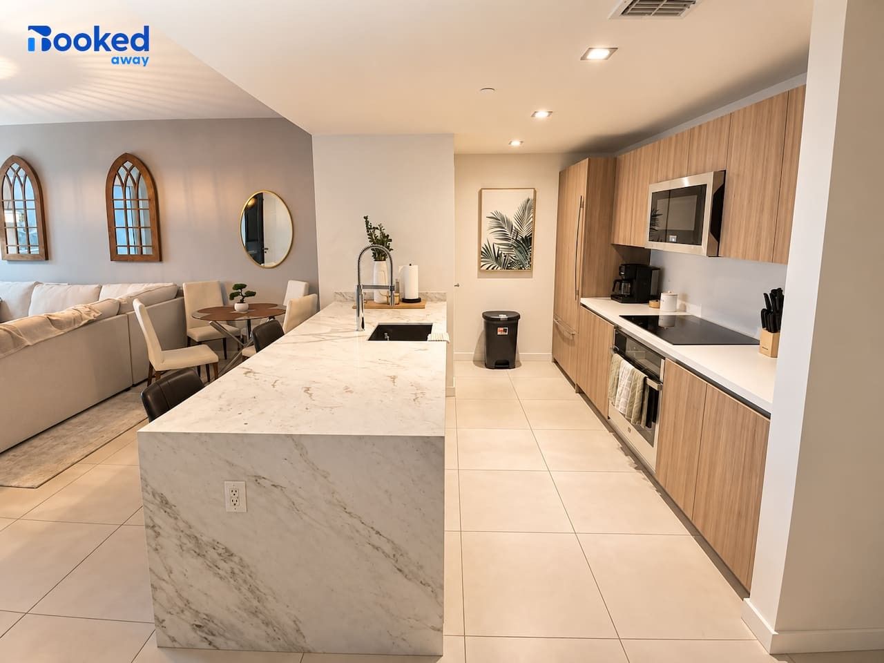 A sleek, modern kitchen with beautiful finishes and a spacious island, perfect for morning coffee, preparing your favorite meals, or enjoying a relaxed evening in.