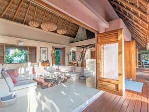 A spacious living area with a wooden ceiling, white sofas, and a wooden coffee table. - Casa Cantarena—Private Beach, 4 Bedrooms, 4 Bathrooms, Chef + Concierge (Quintana Roo)
