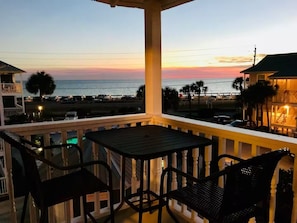 A balcony with a table and chairs overlooking a beach at sunset. - ⭐Across St from Beach Access-Gulf Views-Pool+Hot Tub-Summer Breeze 310⭐ (Miramar Beach)