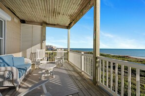 A covered outdoor seating area with a view of the ocean. - Oceanfront 2BR Condo | Pool + Covered Deck + Easy Beach Access (Pine Knoll Shores)