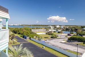 A coastal property with a parking lot, a basketball court, and a view of the ocean and industrial port in the background. - SeaSpray 305 | Oceanview Condo w/ Pool (Atlantic Beach)