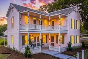 A two-story house with a balcony, a porch, and a front door. - Kuenemann Estate - Pool Table & Poker Room (Fredericksburg)