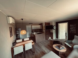 A modern living space with a dining area, kitchen, and seating area. - Stay overlooking the Hardangerfjord | Stunning views (Vestland)