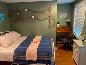 A bedroom with a bed, a desk, and a window. - Enjoy the pool, relax by the fire pit, or spend time exploring North Georgia! (Oakwood)