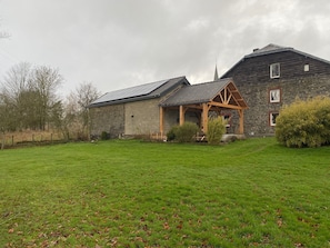 A stone house with a sloped roof and a wooden porch. - Detached Holiday Home in La Roche-en-ardenne (La Roche-en-Ardenne)