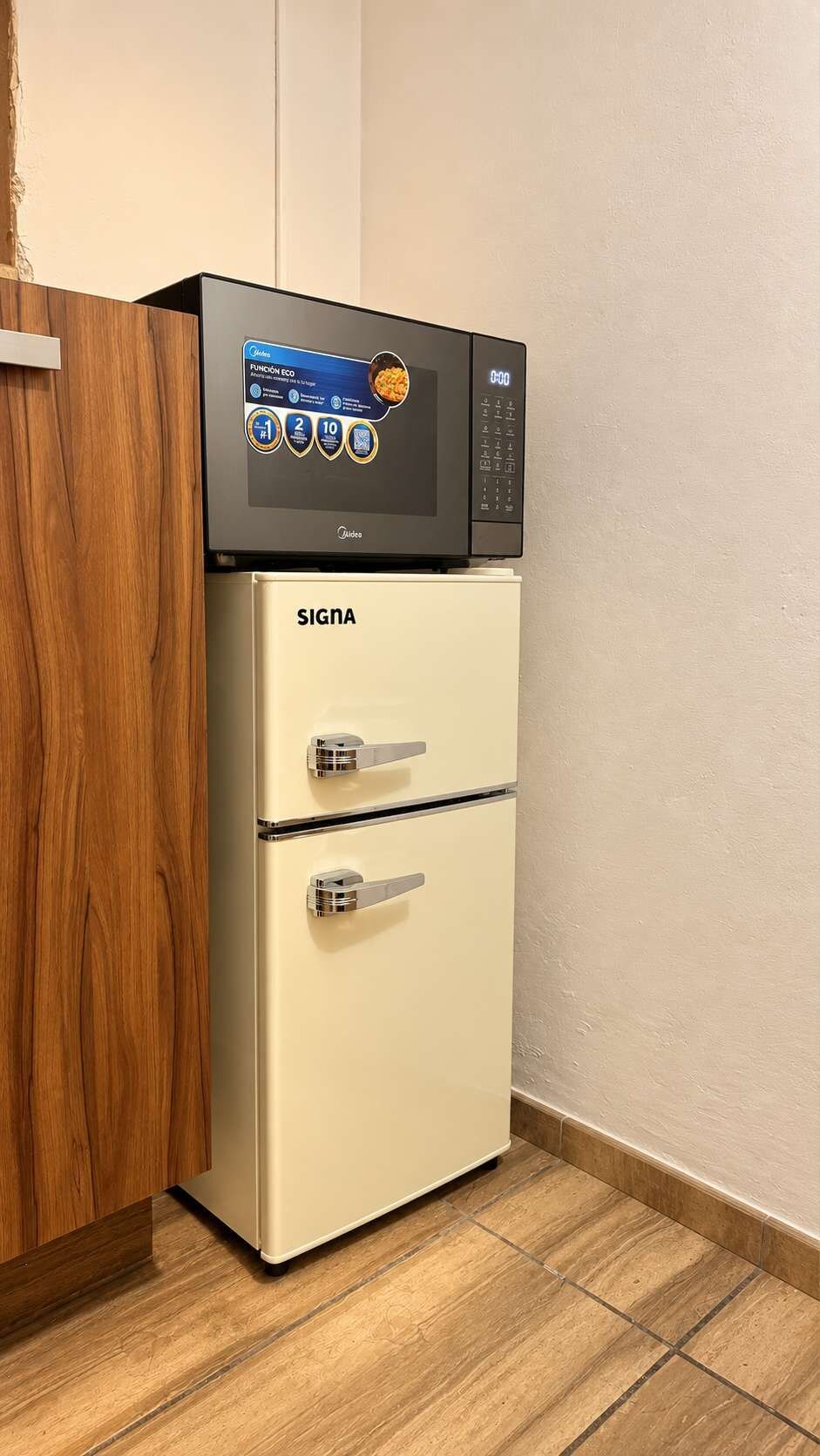 A white refrigerator with a digital display and a microwave on top.