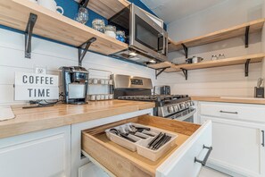 A modern kitchen with a coffee station, a stove, and a sign that reads 'COFFEE TIME'. - A Very Delightful Pearl! (San Antonio)