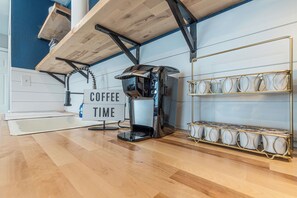 A coffee station with a sign that reads 'COFFEE TIME,' a coffee machine, and a shelf with cups. - A Very Delightful Pearl! (San Antonio)