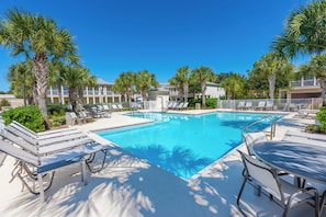 A pool area with lounge chairs and palm trees. - Crystal Dream | Golf Cart, Bikes & Crystal Beach (Destin)