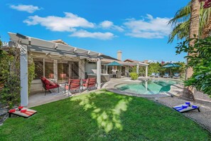 A backyard with a pool, outdoor seating, and a covered patio area. - Private Pool, Spa & Game Room 4BR La Quinta (La Quinta)