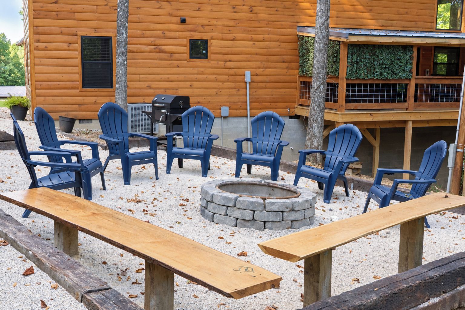 A wooden cabin with a fire pit and outdoor seating area.