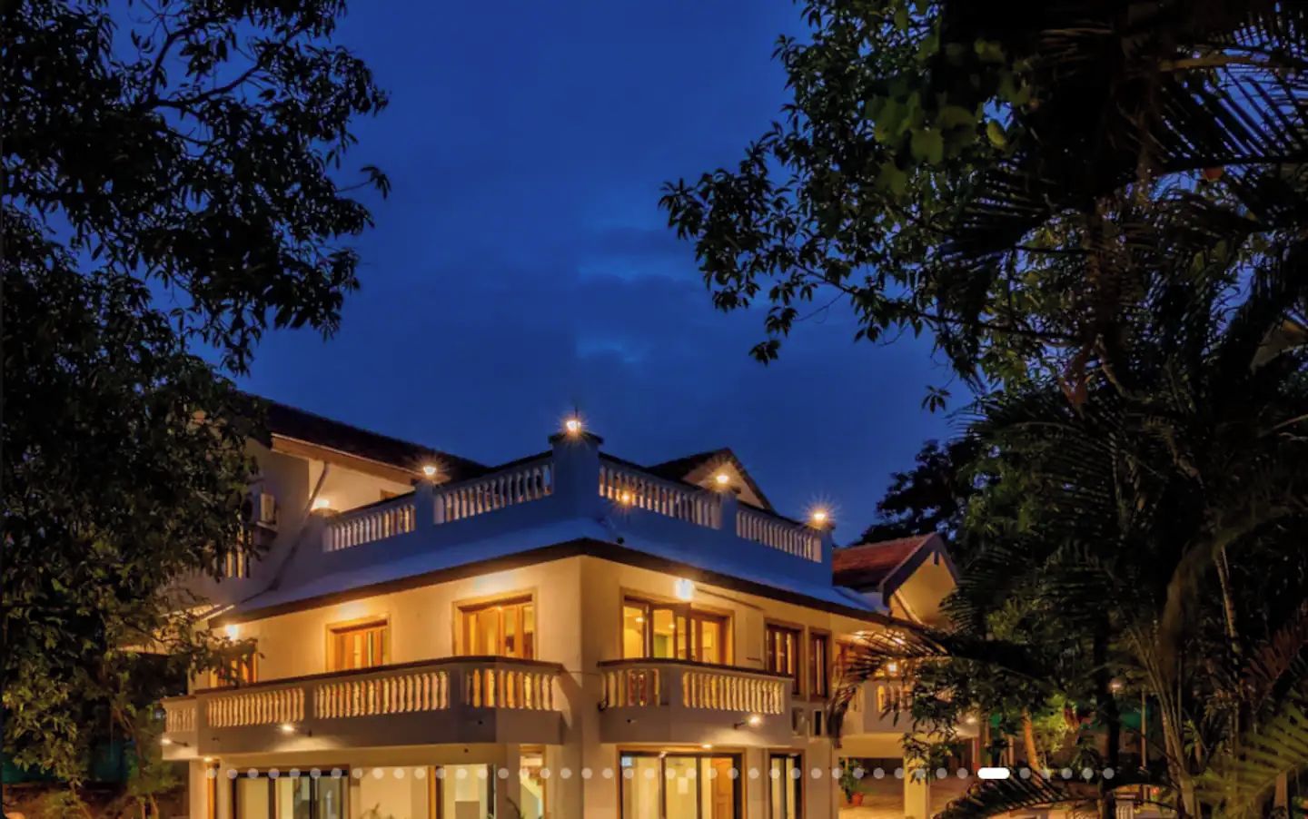 A multi-story building with balconies and warm lighting.
