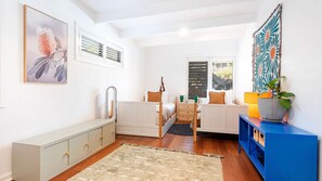 A compact bedroom with a bed, bedside table, and a blue cabinet. - Riverbank Blue - luxe pool, sauna, cabana and family fun moments near Minnamurra's best beaches (Minnamurra)
