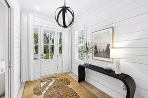 A bright and welcoming entryway greets you with shiplap walls and warm natural light streaming through the glass door, setting the tone for your relaxing stay. - Lakefront | Private Pool | LSV (Santa Rosa Beach)