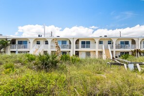 A row of beachfront motel buildings with balconies and stairs leading to the entrance. - Sunrise Ocean Views & Beach Access, 400 Ft to Downtown Cocoa Beach | 1BR Condo, Sleeps 4 (Cocoa Beach)