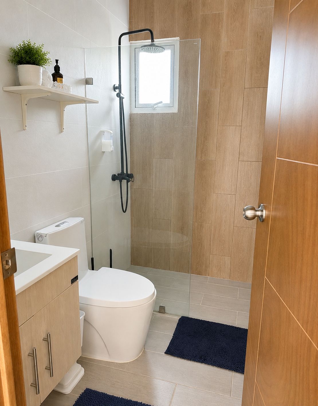 Un baño moderno con inodoro, cabina de ducha y lavamanos.