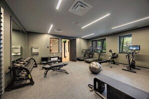 A gym with treadmills, exercise balls, and weight machines. - AMB409 | Steamboat's Newest Luxury Complex | Pool | Hot Tub | Game Room (Steamboat Springs)